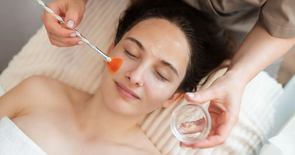 A woman receiving a VI Peel facial treatment from a technician in Plainview, NY